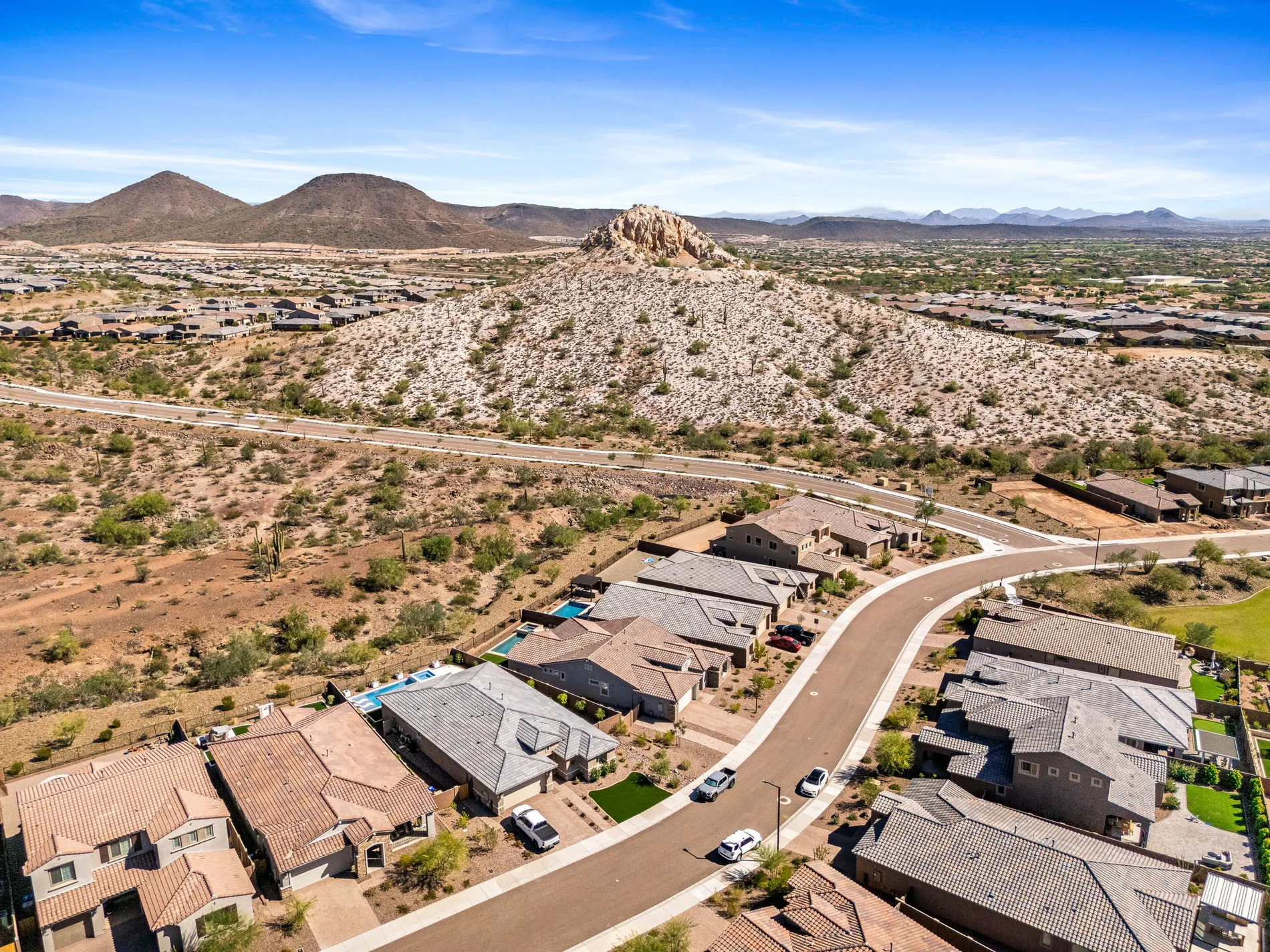 Aerial overview of the neighborhood and surrounding Sonoran Desert hills